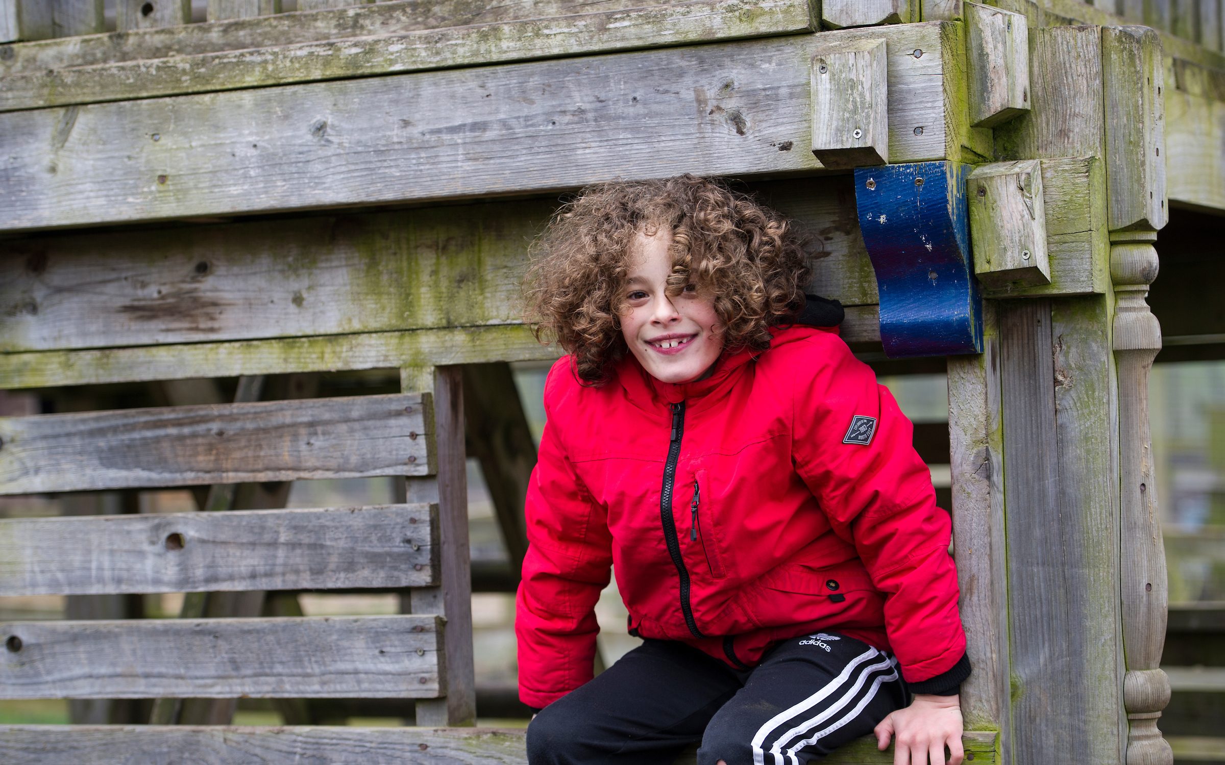 Young lad playing to the Blacon Adventure Playground treehouse