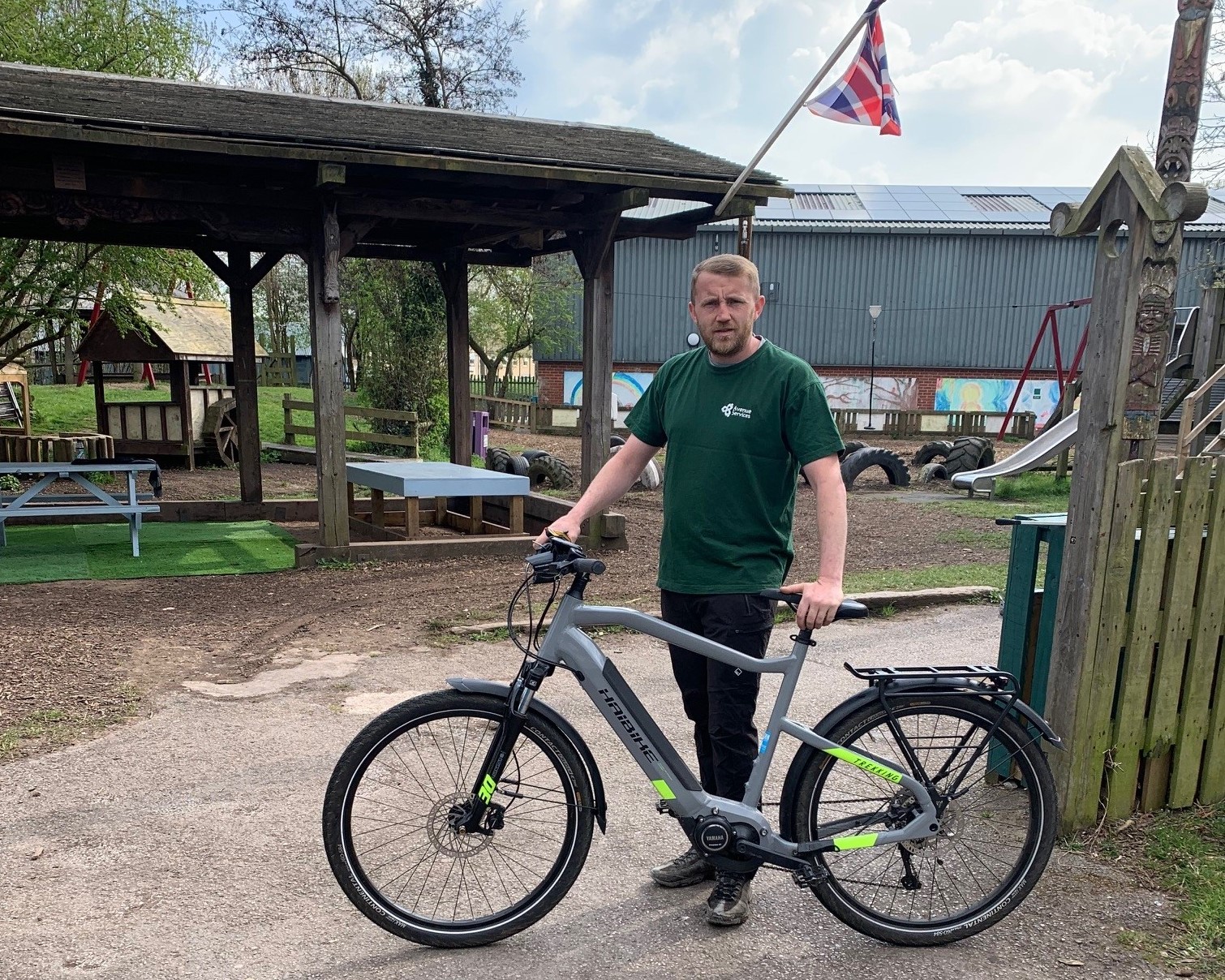 Picture of playworker Liam Evans with his new electric bike